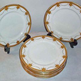 Eleven Aynsley gilded dinner plates