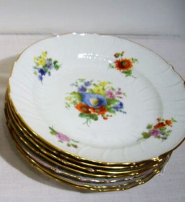 Set of KPM Berlin dinner plates, each painted with different flower bouquets