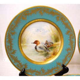 Close up of one of the six Minton bird plates signed Holland