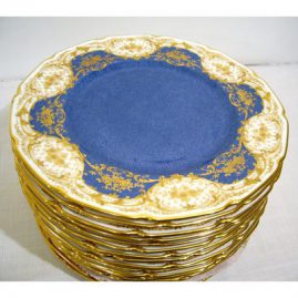 Sixteen Royal Doulton stippled blue with raised gilding dinner plates, all fluted