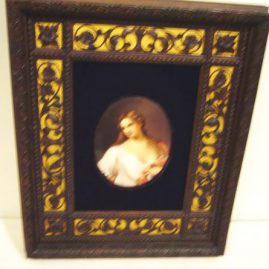 Porcelain plaque of lady in fabulous wood carved frame