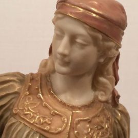 Close up of the Royal Worcester figure of a lady with a shovel