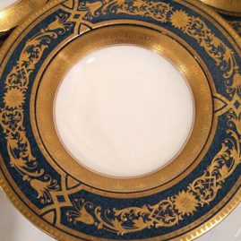 Close up of Royal Worcester blue plates with raised gilding wide rim soup bowls