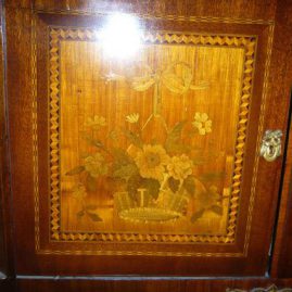 Close up of marquetry inlay of inlaid marble top cabinet
