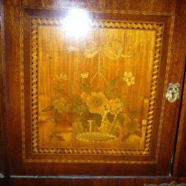 Close up of marquetry inlay of inlaid marble top cabinet