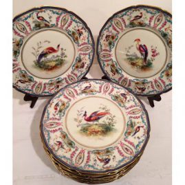 Set of twelve rare Royal Doulton exotic bird plates, hand enameled and signed E. Wood.