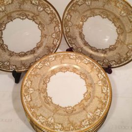 Set of eleven Royal Doulton dinner plates with raised gilding