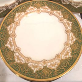 Close-up of set of twelve profusely gilded green Royal Doulton dinner plates