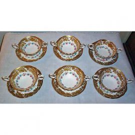 13 Hammersley raised gilt cream soups and saucers made for Ovington Brothers, N.Y