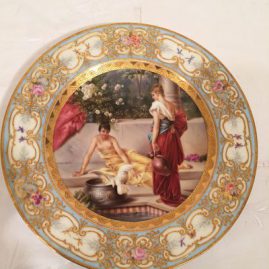 Royal Vienna plate with painting of two ladies and a bird on a veranda