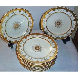 12 Minton dinner plates with raised gilding and gilt jeweling