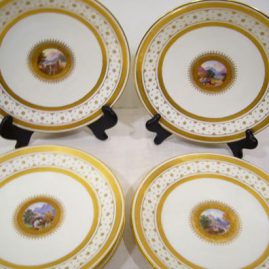 Set of eight Minton scenic plates, each painted with different scenes