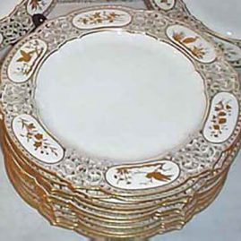 Set of twelve Sevres reticulated plates each hand gilded differently