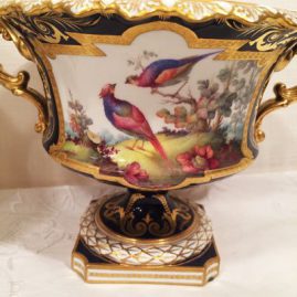 Close up of one of the Royal Crown Derby pair of vases with different bird decorations