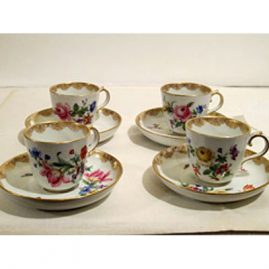 Four Meissen demitasse cups and saucers with different bouquets of flowers on each one