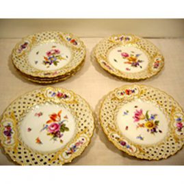 Set of eleven rare Meissen reticulated plates, each handpainted with different bouquets of flowers and bugs