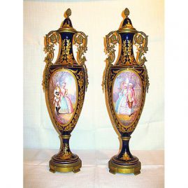 Pair of Sevres urns artist signed in cobalt and raised gold
