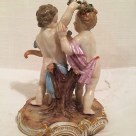 Back of girl and boy putti with flowers and cornocopia