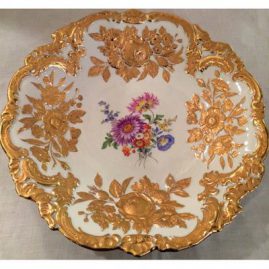 Large round Meissen gilded charger with flower bouquet decoration, and raised gold flowers accenting the charger. 12 inch diameter. Price on Request