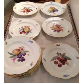 Set of twelve Meissen fruit plates, each painted with different fruits and bug