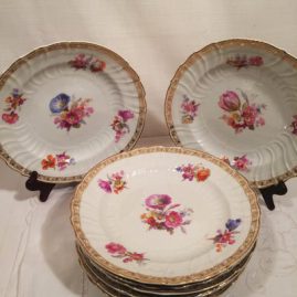 Set of twelve KPM dinner plates, each painted with different bouquets of flowers