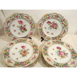 Set of twelve Dresden reticulated dinner plates, each painted with different bouquets of flowers