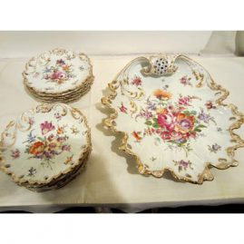 Beautiful Dresden set with twelve dessert plates and rare platter. Each plate is painted differently with different bouquets of flowers