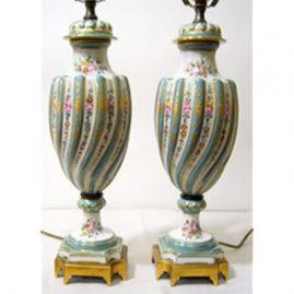 Pair of Sevres style lamps with raised gilding and hand painted flower