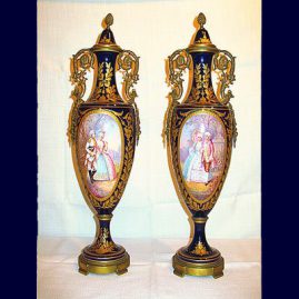 Pair of "Sevres" cobalt urns beautifully painted with scenes of lovers