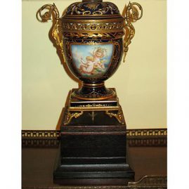 Close up of one of a pair of French cherub lamps