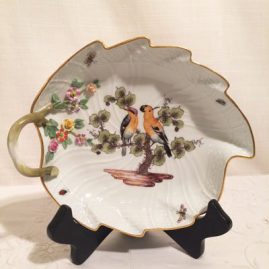 Meissen leaf shaped dish painted with birds and bugs.