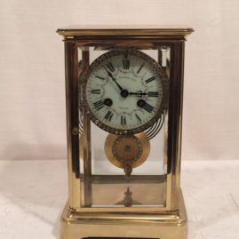 French late nineteenth century brass and glass clock with beveled glass on front and sides