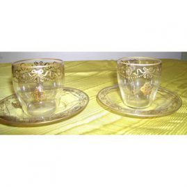 8 demitasse cups and saucers with raised gilding with bows and swags