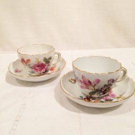 Set of 10 Meissen cups and saucers each painted with different flower bouquets.