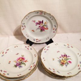 Set of ten Meissen dessert plates, each painted witSet of ten Meissen dessert plates, each painted with different flower bouquets. different flower bouquets.