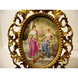 Porcelain plaque artist signed Wagner in Venetian frame of two ladies in a garden,