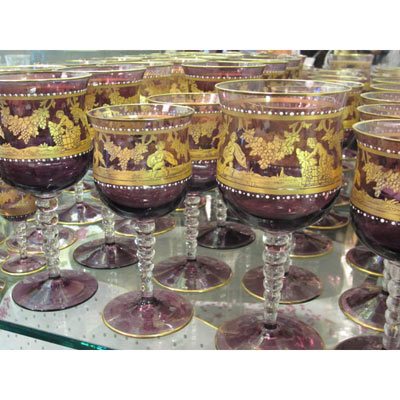 Large set of amethyst Salviati stemware with white enamel jeweling and painted with gilt cherubs at harvest time.
