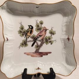Meissen bowl painted with birds and bugs.