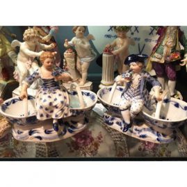 Pair of Meissen blue onion double salt cellars with figures of a boy and girl.