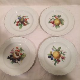 Meissen dessert plates with fruit paintings.
