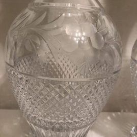 Close up of the pair of tall cut and wheel cut crystal tall decanters.