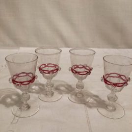 Set of four Salviati Venetian cordials with applied pink ribbon and raised crystal balls