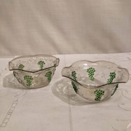 Another view of two of the set of eight Venetian bowls with the raised grape and vine decoration