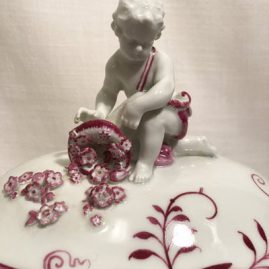 Close up of the putti on the top of the pink onion tureen.