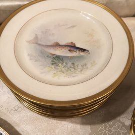 Close up of onr of twelve Lenox fish plates artist signed W.H. Morley