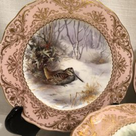 Close up of one of the set of twelve elaborately painted bird plates