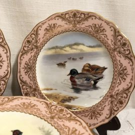 Close up of one of the set of twelve elaborately painted bird plates