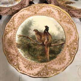 Close up of one of the set of twelve elaborately painted bird plates