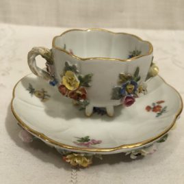Picture of one of the six Meissen demitasse cups and saucers with raised flowers