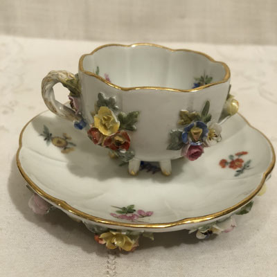Picture of one of the six Meissen demitasse cups and saucers with raised flowers